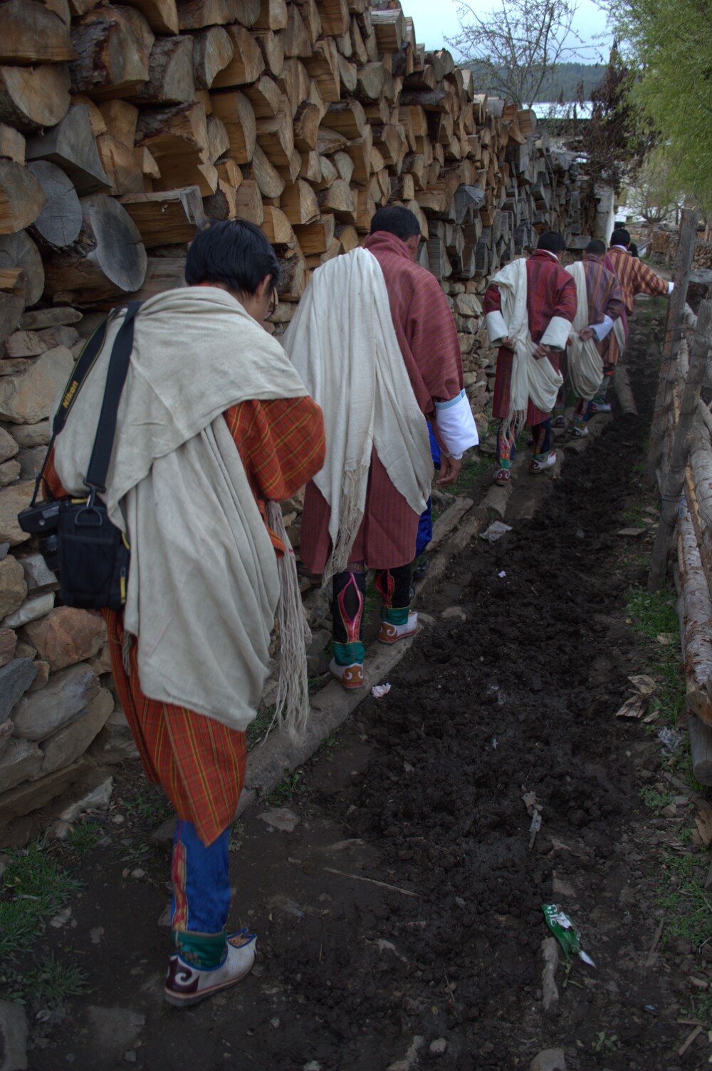 Men walking to a neighbor’s house for drinks.