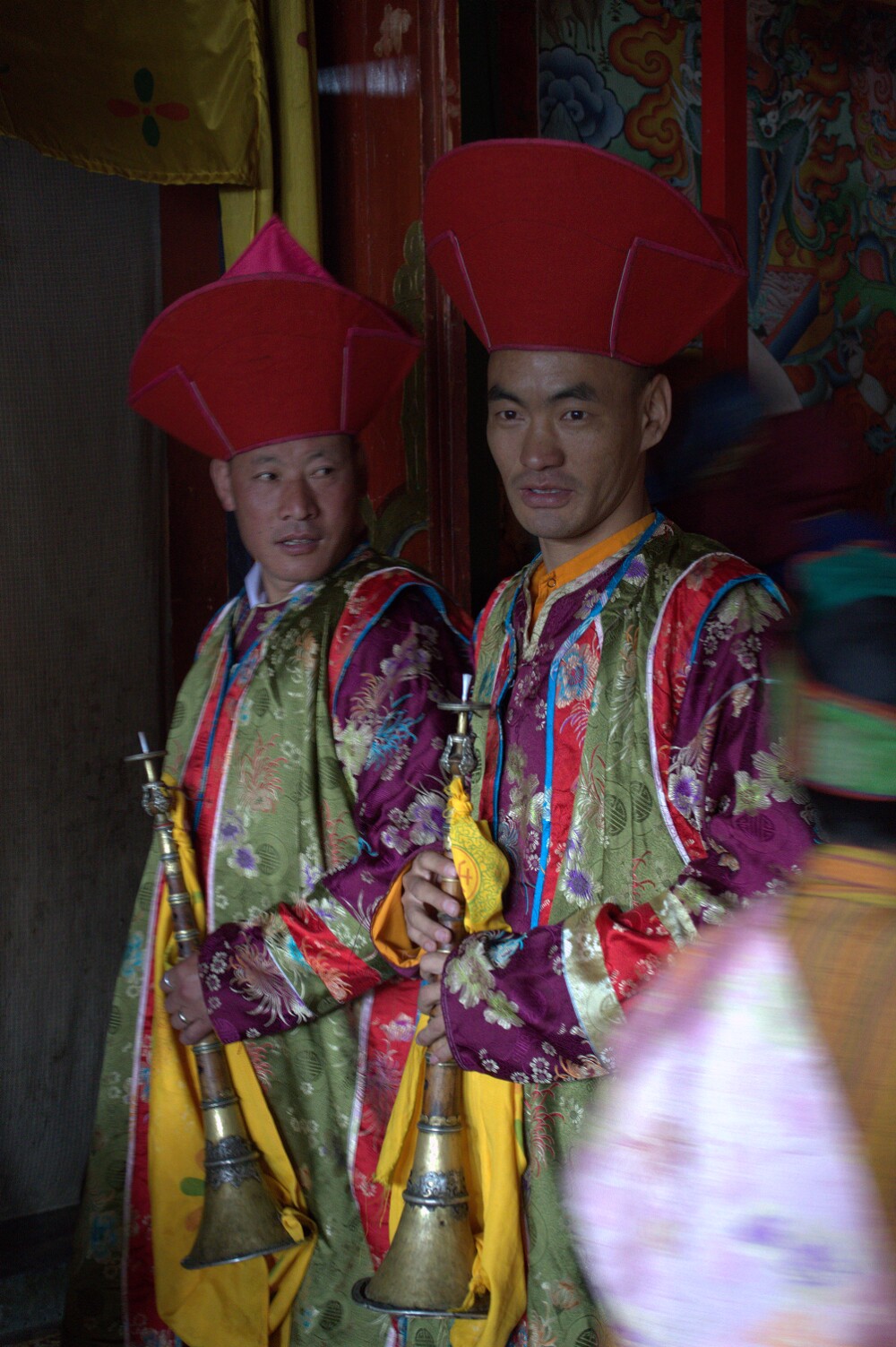 Jahling players stand outside the Ura Lhakhang, waiting for the chibdrel to begin.